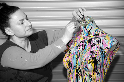 Giovanna at work in her studio, painting on a modelling torso